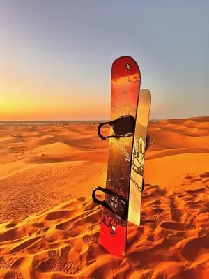 a snowboard sitting in the sand in the desert at Kabana Sahara Luxury Camp in Merzouga