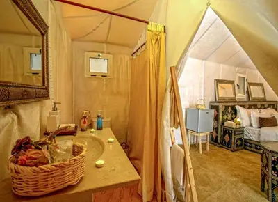 a room with a tent with a sink in it at Kabana Sahara Luxury Camp in Merzouga