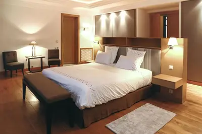 a bedroom with a bed and a desk and a chair at Mexance Villa with large hosting capacity, private heated pool, Fitness and SPA in Oulad Mazoug