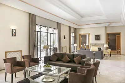 a living room with a couch and chairs and a table at Mexance Villa with large hosting capacity, private heated pool, Fitness and SPA in Oulad Mazoug