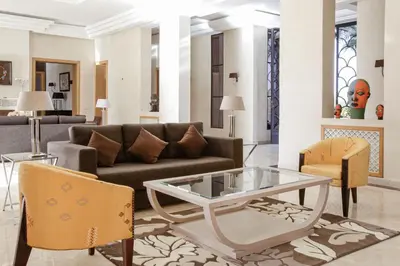 a living room with a couch and a table at Mexance Villa with large hosting capacity, private heated pool, Fitness and SPA in Oulad Mazoug