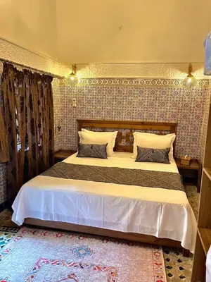 a bedroom with a large bed in a room at Dar Al Batoul Meknes in Meknès