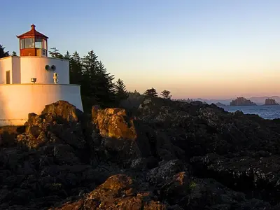 a lighthouse sitting on top of a rocky island at Milano in Oulad Akkou
