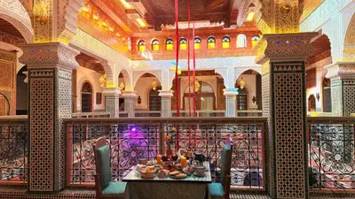 a dining room with a table with food on it at Riad Fes Bab Sahra Palace in Fès