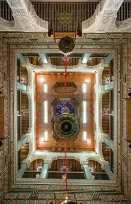 a ceiling of a building with a clock on it at Riad Fes Bab Sahra Palace in Fès