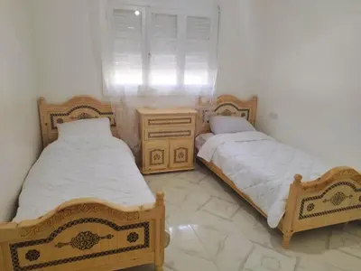 two beds sitting next to each other in a room at Villa spacieuse 3 chambres à l'entrée de la ville in Imouzzer Kandar