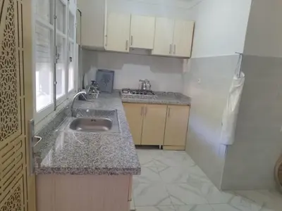 a kitchen with a sink and a counter top at Villa spacieuse 3 chambres à l'entrée de la ville in Imouzzer Kandar