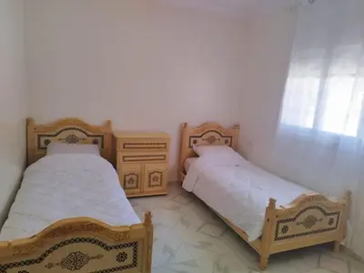 two beds sitting next to each other in a room at Villa spacieuse 3 chambres à l'entrée de la ville in Imouzzer Kandar