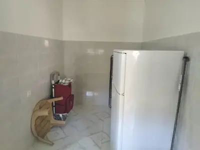 a kitchen with a refrigerator and a tiled floor at Villa spacieuse 3 chambres à l'entrée de la ville in Imouzzer Kandar