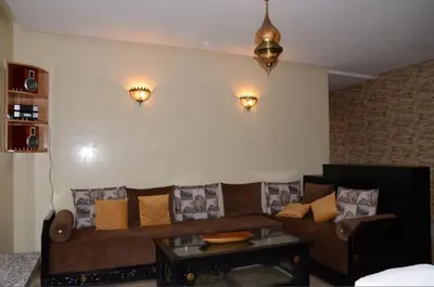 a living room with a couch and a coffee table at Apartment with large terrace and pool in Fès