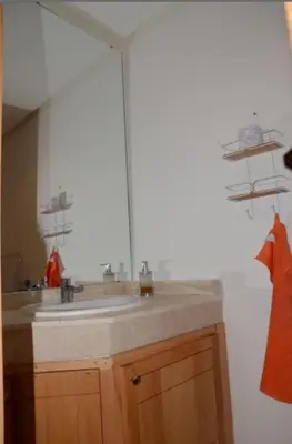 a bathroom with a sink and a mirror at Apartment with large terrace and pool in Fès