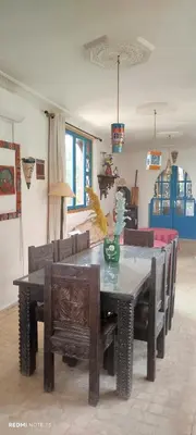 a dining room with a table and some chairs at Maison des maitres in Tafza