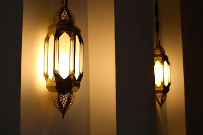two lights are hanging on the wall at Riad Yamcha in Meknès