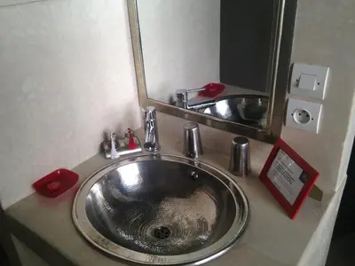 a bathroom sink with a large mirror above it at Riad Yamcha in Meknès