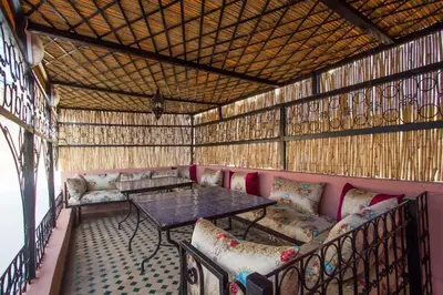 a room with a table and chairs in a building at Dar Miouda Fes in Fès
