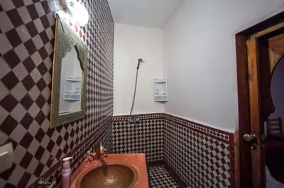a bathroom with a sink and a mirror at Dar Miouda Fes in Fès