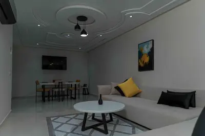 a living room with a couch and a table at Appart Hôtel Golden Sky Home in Beni Mellal