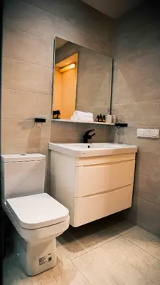 a bathroom with a toilet and a sink and a mirror at Appart Hôtel Golden Sky Home in Beni Mellal
