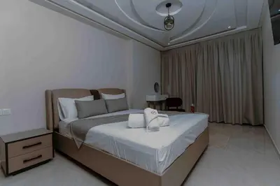 a bedroom with a bed with two towels on it at Appart Hôtel Golden Sky Home in Beni Mellal