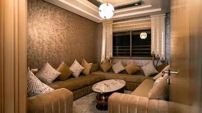 a living room with a couch and a window at Appart Hôtel Golden Sky Home in Beni Mellal