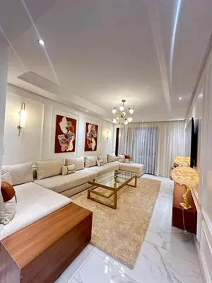 a living room with a couch and a table at Ennaim Garden Loft in Oulad Akkou