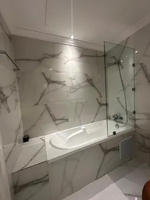 a bathroom with a sink and a glass shower at Ennaim Garden Loft in Oulad Akkou