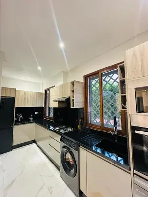 a kitchen with a washer and a dishwasher at Ennaim Garden Loft in Oulad Akkou