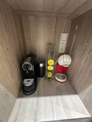 a corner of a wooden box with appliances in it at Ennaim Garden Loft in Oulad Akkou