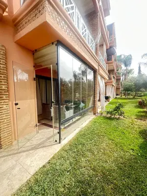 a glass door on the side of a building at Ennaim Garden Loft in Oulad Akkou
