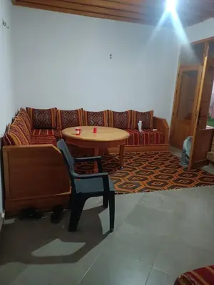 a living room with a table and a couch at Villa en montage in Khenifra