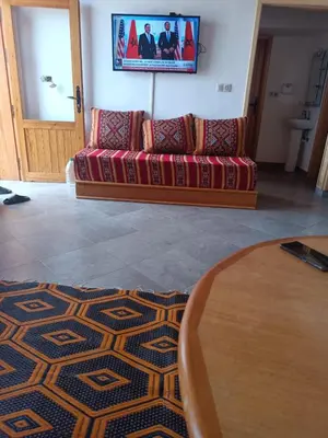 a living room with a couch and a tv at Villa en montage in Khenifra