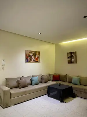 a living room with a couch and a table at Nura Apartment - Family only in Oulad Akkou