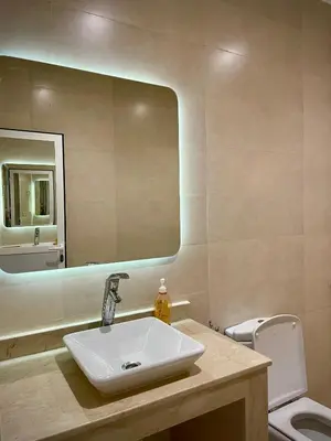 a bathroom with a sink and a mirror and a toilet at Nura Apartment - Family only in Oulad Akkou