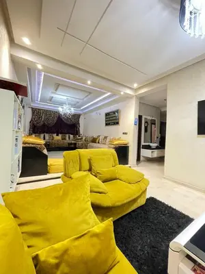 a living room with yellow couches at Aicha alaoui ismaili in Fès