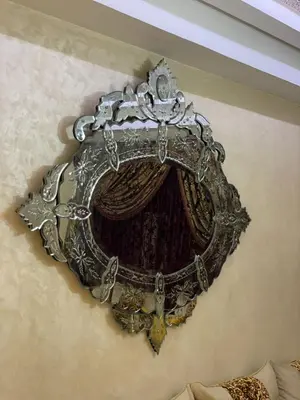 a crown hanging on a wall with a curtain at Aicha alaoui ismaili in Fès