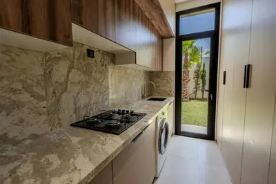 a kitchen with a stove top oven next to a window at Villa Famililale Shanya in Marrakech