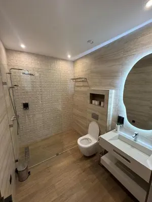 a bathroom with a toilet and a shower and a sink at Villa Famililale Shanya in Marrakech