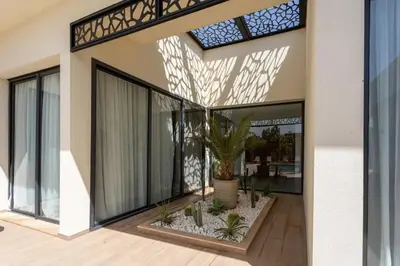 a house with a large glass door with a plant at Villa Famililale Shanya in Marrakech