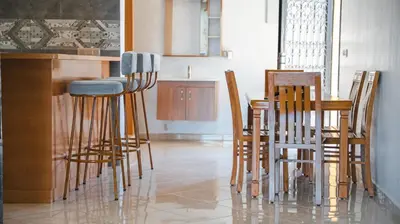 a kitchen with wooden chairs and a table at villa Folki in Oulad Zbir