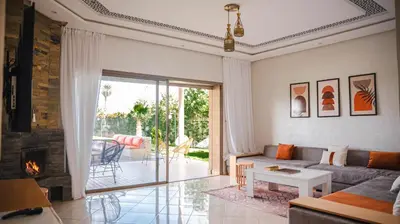 a living room with a couch and a fireplace at villa Folki in Oulad Zbir