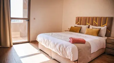 a bedroom with a large bed with a large window at villa Folki in Oulad Zbir