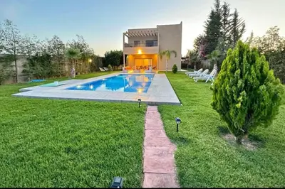 a house with a swimming pool in the yard at villa Folki in Oulad Zbir
