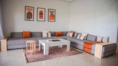 a living room with a couch and a table at villa Folki in Oulad Zbir