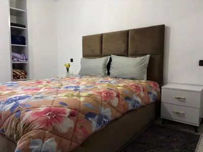 a bedroom with a large bed with a colorful comforter at Spacious Apartment in the heart of downtown Fez in Fès