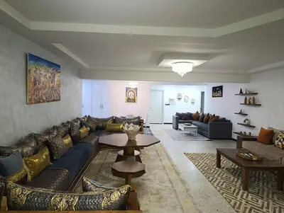 a living room with a couch and a table at Spacious Apartment in the heart of downtown Fez in Fès