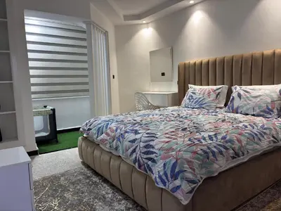a bedroom with a bed with a blanket and pillows at Spacious Apartment in the heart of downtown Fez in Fès