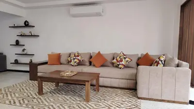 a living room with a couch and a coffee table at Spacious Apartment in the heart of downtown Fez in Fès