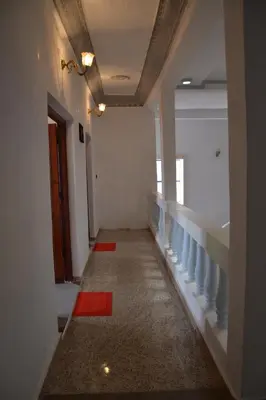a hallway with a staircase with blue and red accents at La Belle Vue Guest House in Aït Ben Haddou