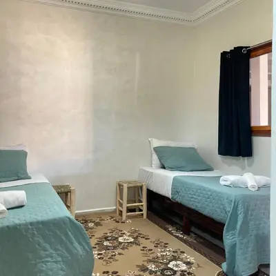 a room with two beds and a window at La Belle Vue Guest House in Aït Ben Haddou
