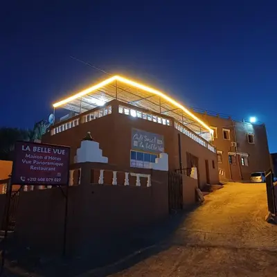 a building with lights on top of it at night at La Belle Vue Guest House in Aït Ben Haddou